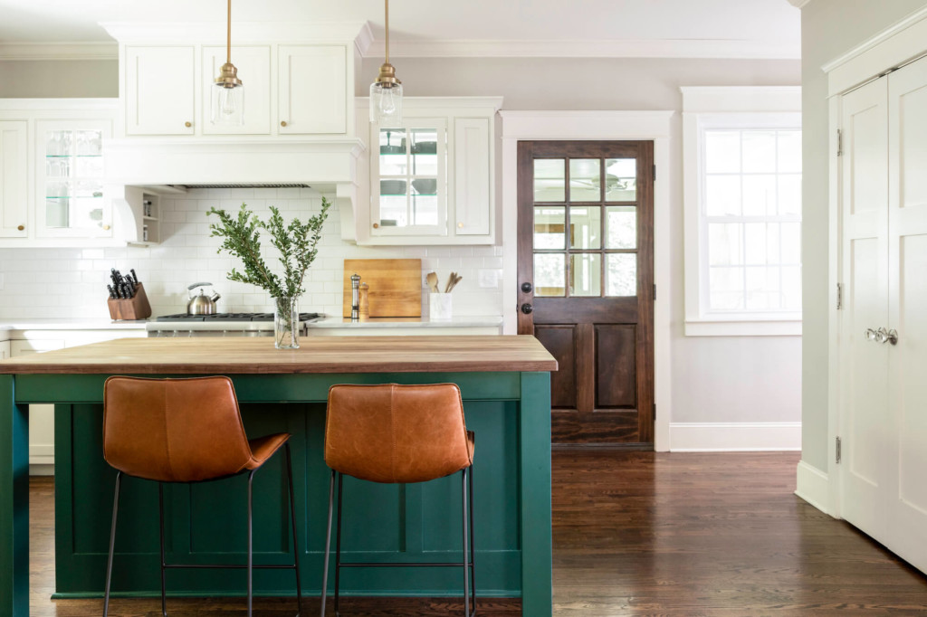 kitchen with white upper cabinet and green island