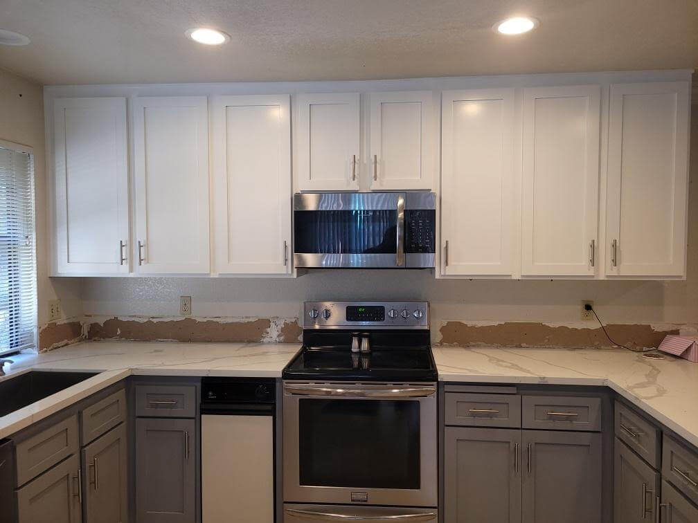 white and gray kitchen cabinets and kitchen appliances after cabinet refacing