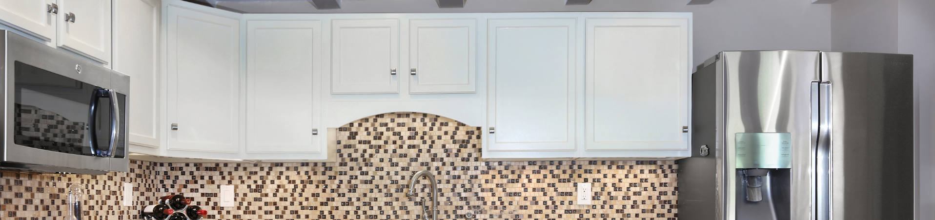 Photo of kitchen with blue and white refinished cabinets