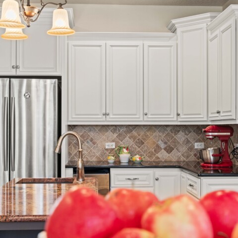 white kitchen cabinets with red wall