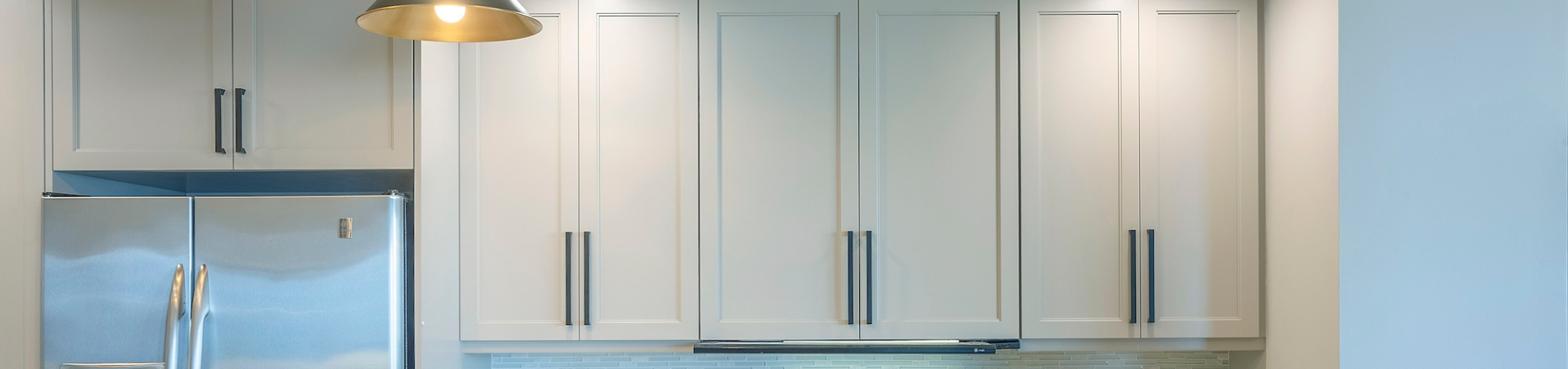 Photo of kitchen with blue and white refinished cabinets