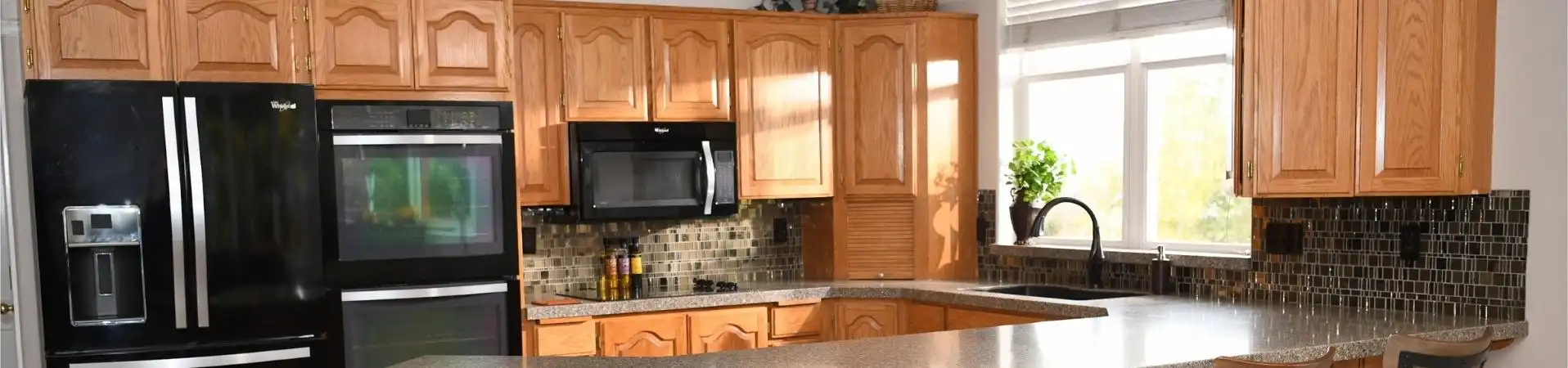 Photo of kitchen with old cabinets before refinishing