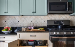 Kitchen with light blue overhead cabinets and beige lower cabinets