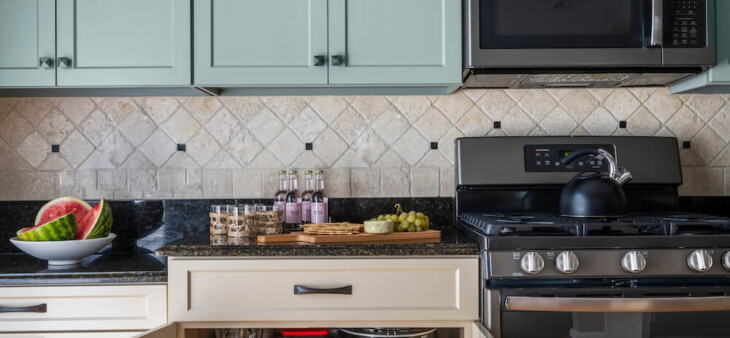 Kitchen with light blue overhead cabinets and beige lower cabinets